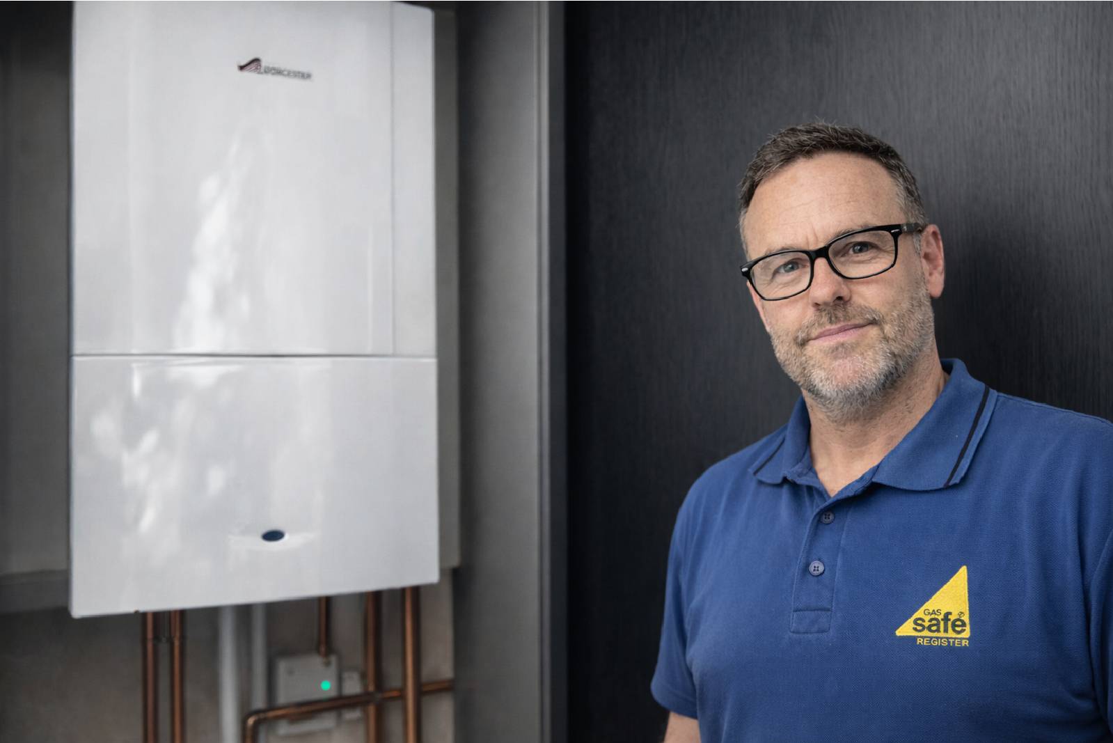Engineer next to boiler during a boiler service by JB Gas and Heating