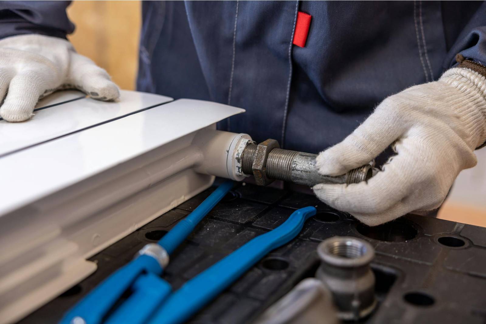 Radiator installation in progress, showcasing a professional plumber at work